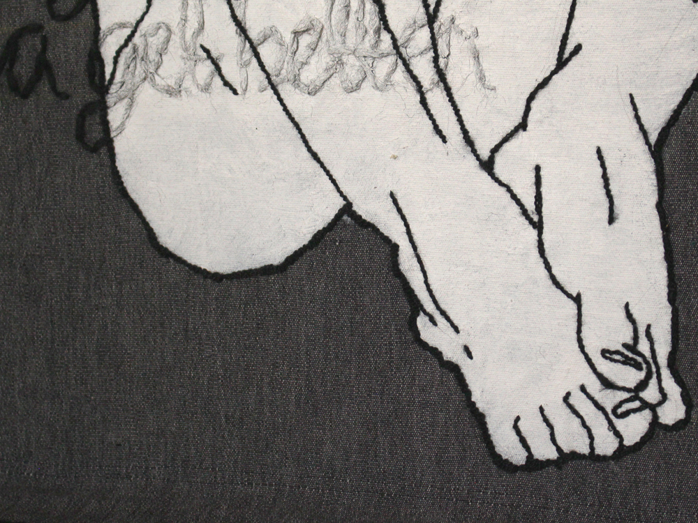 A closee up photo of a black yarn embroidery on a grey fabric. Visible is the naked bottom and feet of a person sitting down. The body is filled in with white paint.